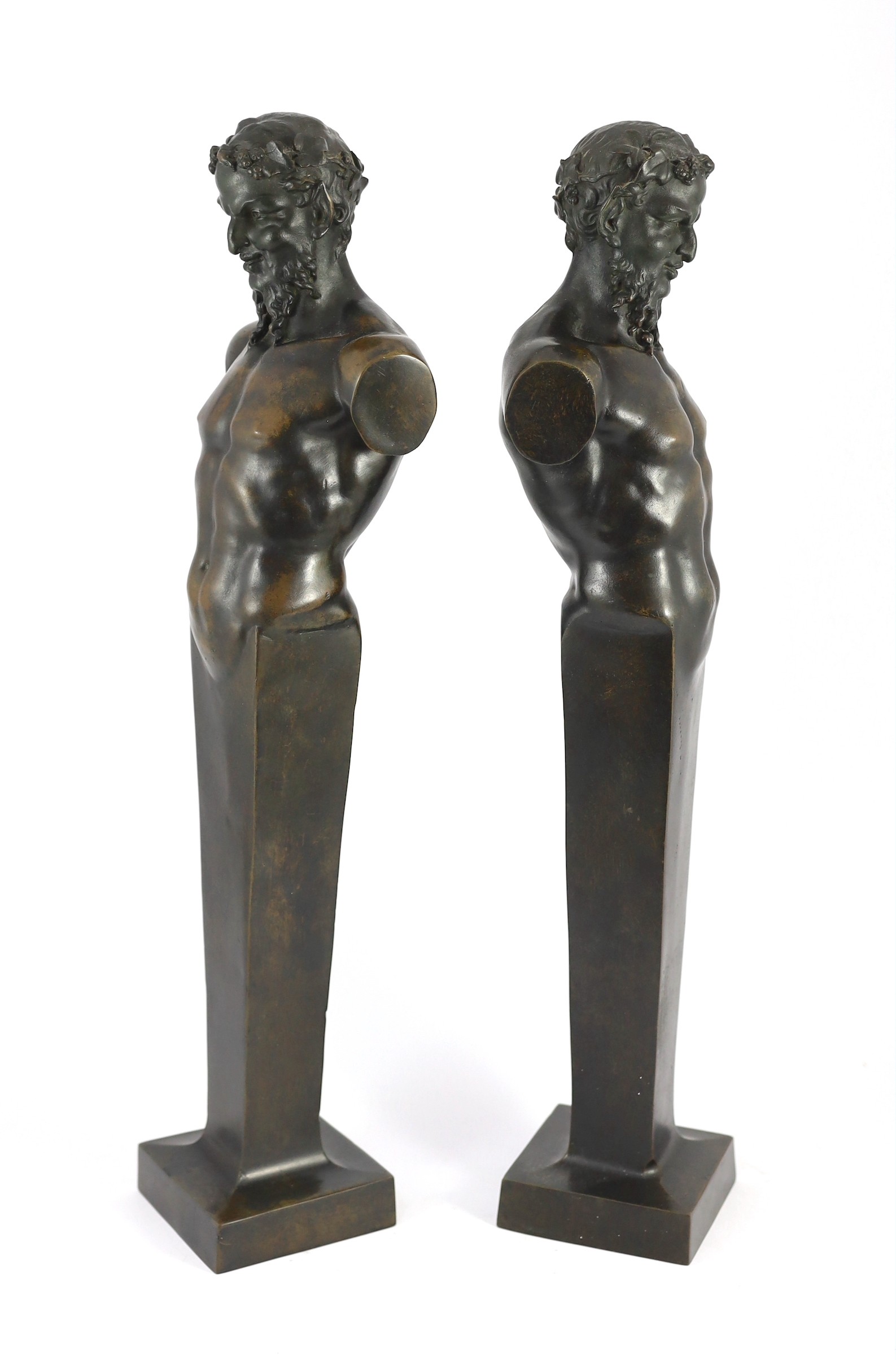 A pair of early 20th century French bronze terms, each in the form of a satyr, 16cm wide 62cm high